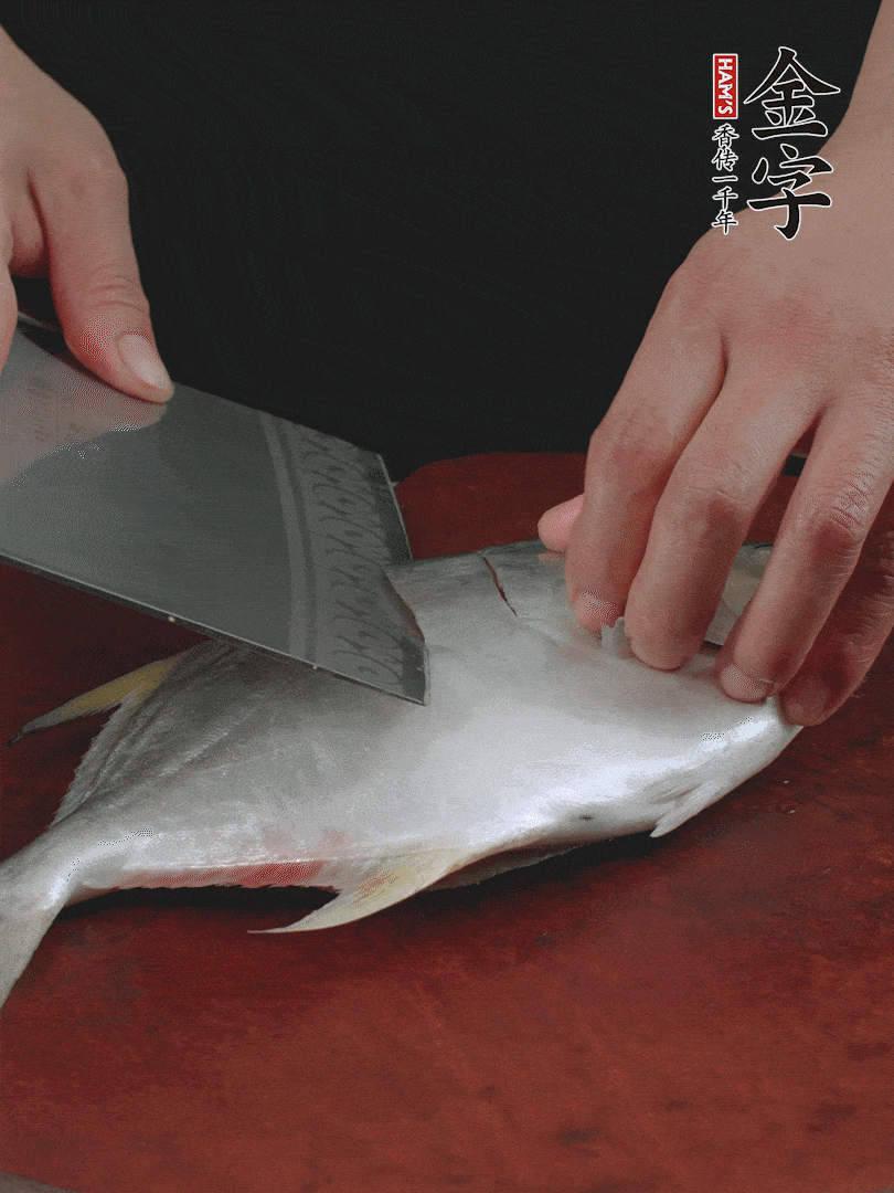 處理干凈銀鯧魚1條，表面斜刀切出花刀。